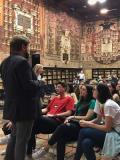 Jonathan Combs-Schilling standing in an ornate classroom