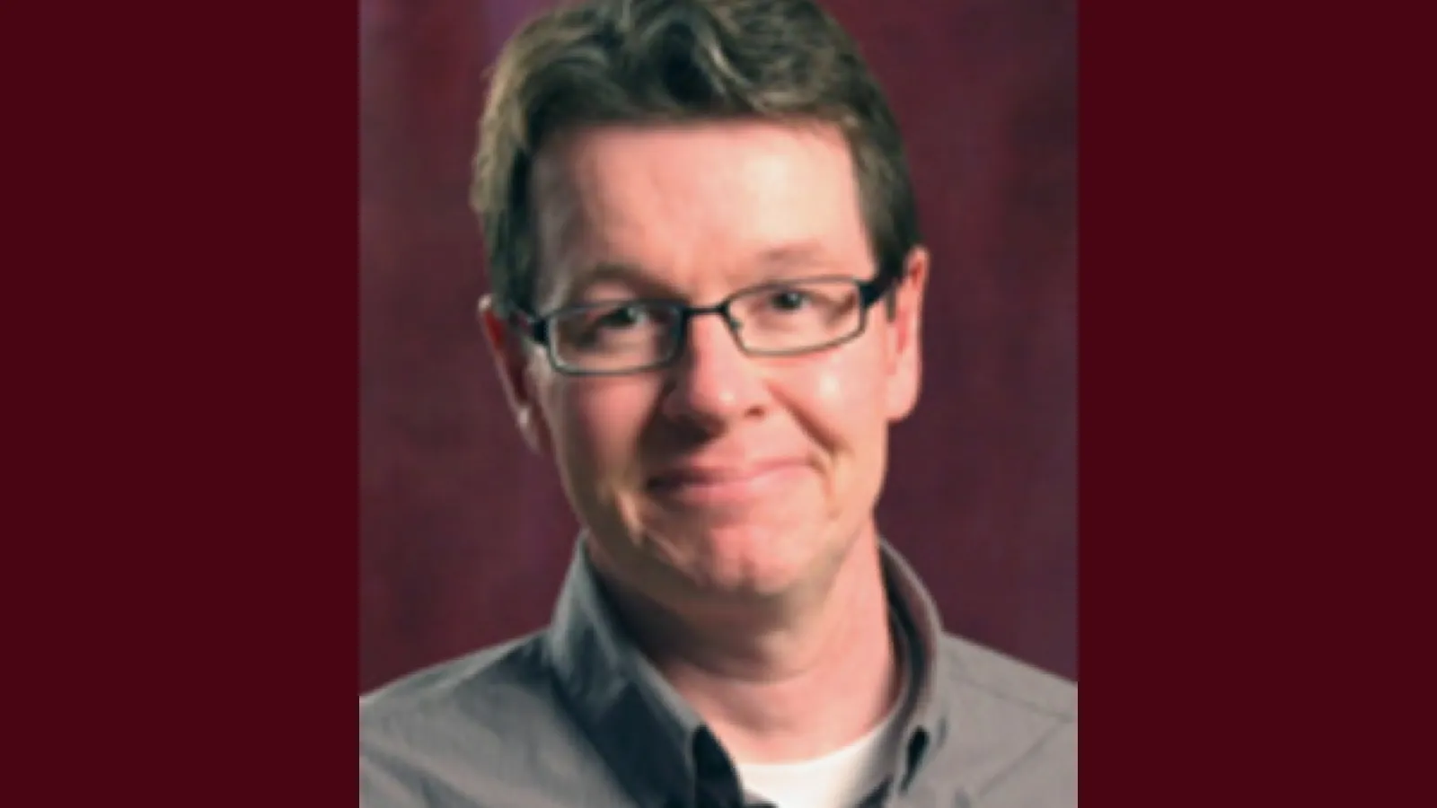 Headshot of Chris Highley, a white man with small glasses and short brown hair