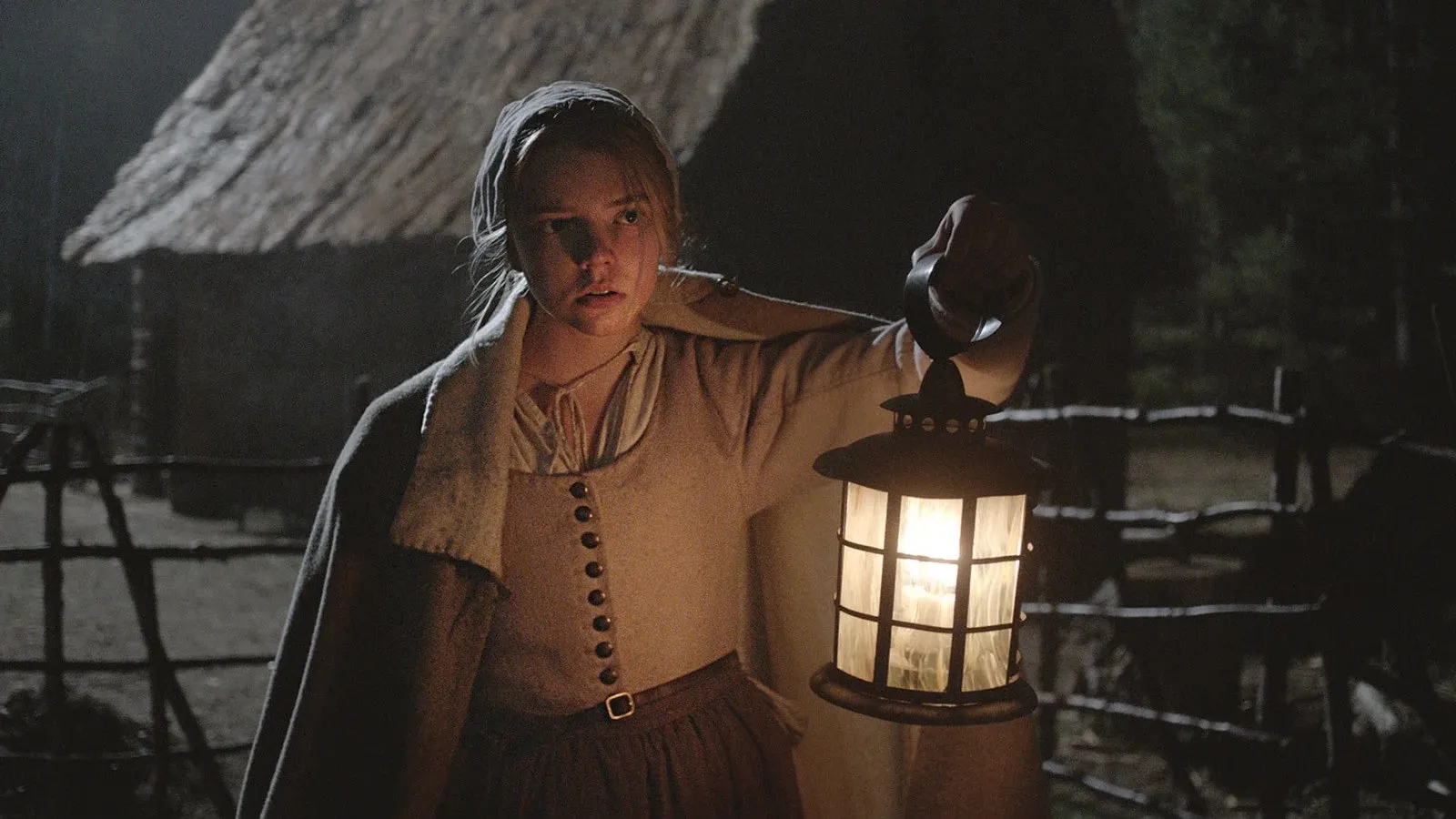 A young Puritan girl holds a lantern in the dark.