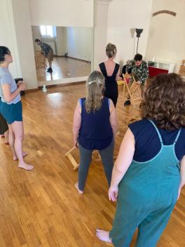 Dancers using chairs as props