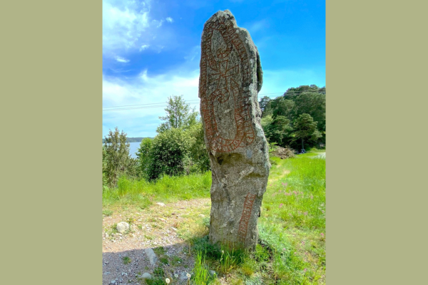 A tall rock standing in a field
